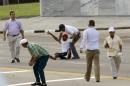 One of two unidentified men is grabbed by a security officer after they threw leaflets as Pope Francis arrives for a Mass at Revolution Plaza in Havana, Cuba, Sunday, Sept. 20, 2015. Francis will not be meeting with dissidents during his visit, sparking critiques from the political opposition who say they feel let down by an institution they believe should help push for greater freedom in Cuba. (AP Photo/Ramon Espinosa)