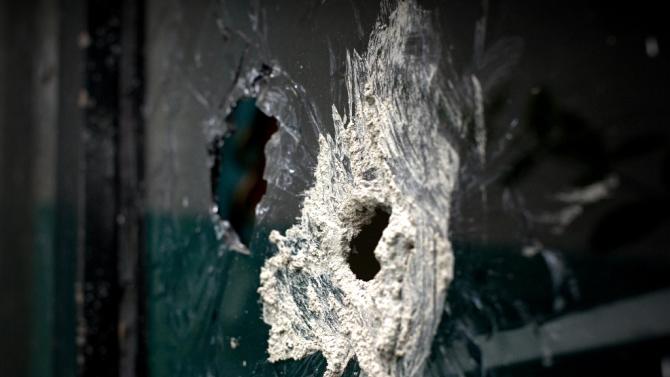 Bullet holes scar the window of a neighbouring house to that where gunmen attacked the police in in Ocotlan