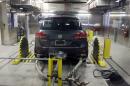 A Volkswagen Touareg diesel is tested in the Environmental Protection Agency's cold temperature test facility, Tuesday, Oct. 13, 2015, in Ann Arbor, Mich. Volkswagen has disclosed to U.S. regulators that there's additional suspect software in its 2016 diesel models that would potentially help their exhaust systems run cleaner during government tests. (AP Photo/Carlos Osorio)