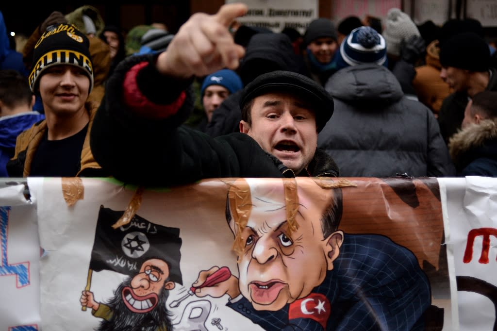 A protester shouts slogans during a demonstration in front of the Turkish embassy in Moscow on November 25, 2015