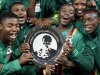 Zambia soccer players celebrate with the Nelson Mandela Challenge trophy after beating South Africa at Soccer city outside Soweto