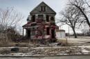 A vacant and blighted home, covered with red spray paint, sits alone in an east side neighborhood once full of homes in Detroit