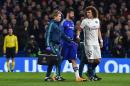 Paris Saint-Germain's defender David Luiz (R) shakes hands as Chelsea's striker Diego Costa (C) leaves the pitch after getting injured during the UEFA Champions League round of 16 second leg football match in London on March 9, 2016
