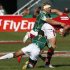 South Africa's Brown and Dazel tackle Wales' Smith during their Sevens World Series Plate semi-final rugby match at The Sevens stadium in Dubai