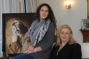 In a file picture taken on November 10, 2011, Suha Arafat poses with her daughter Zahwa Arafat (L) in front of a portrait of her late husband Yasser Arafat in Malta