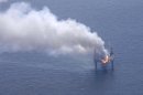 A fire is seen on the Hercules 265 drilling rig in the Gulf of Mexico off the coast of Louisiana, Wednesday, July 24, 2013. Natural gas spewed uncontrolled from the well on Tuesday after a blowout that forced the evacuation of 44 workers aboard the drilling rig, authorities said. No injuries were reported in the blowout. (AP Photo/Gerald Herbert)