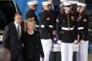 U.S. President Obama walks with Secretary of State Clinton past the flag-draped transfer case of one of four Americans who died this week in Libya, during a transfer of remains ceremony at Andrews Air Force Base