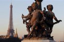 A statue decorates the Alexandre III Bridge which crosses the River Seine near the Eiffel Tower in Paris
