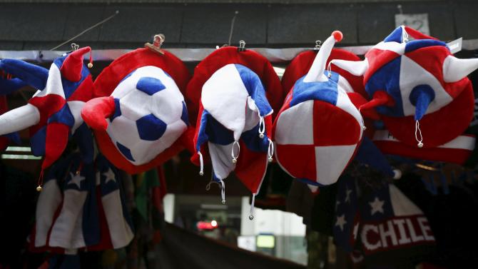 Hats with the colors of the flag of Chile are displayed for sale in Temuco, Chile