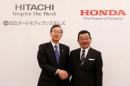 Honda Chief Executive Officer Takahiro Hachigo and his Hitachi Automotive counterpart Hideaki Seki shake hands at a photo session after their news conference in Tokyo