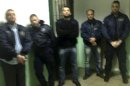 This photo taken by an unnamed prisoner with a cellphone shows hostages, both prison officers and prisoners, being held by Albanian convict Alket Rizaj at Malandrino prison, in central Greece, on Saturday, March 16, 2013. Rizaj is demanding to be allowed to leave the prison, claiming to be heavily armed. Police special forces have deployed outside the prison, while prison officers, Rizaj's lawyer, and a prosecutor try to negotiate with him. (AP Photo)