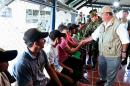 Colombia's Defense Minister Luis Carlos Villegas (R) greets the group of fishermen who had been held by the ELN (Army of National Liberation) on January 16, 2016 in Aguachica, Colombia