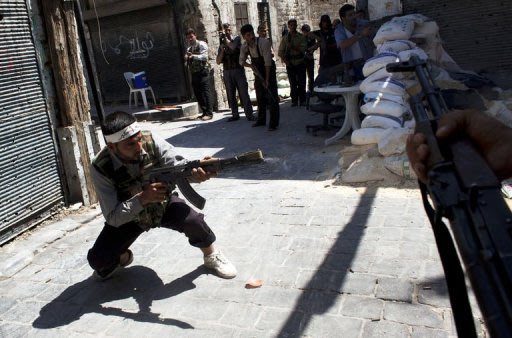Syrian fighters with the Free Syria Army (FSA) take position during clashes with government forces
