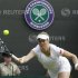 Kim Clijsters of Belgium hits a return to Jelena Jankovic of Serbia during their women's singles tennis match at the Wimbledon tennis championships in London