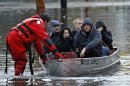 Residents are rescued by emergency personnel from flood waters brought on by Hurricane Sandy in Little Ferry