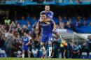 Chelsea's John Terry (top) and Gary Cahill celebrate victory after the final whistle of their English Premier League match against Manchester United, at Stamford Bridge in London, on April 18, 2015