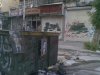Pictures of Syria's President Bashar al-Assad hang from garbage containers in Aleppo