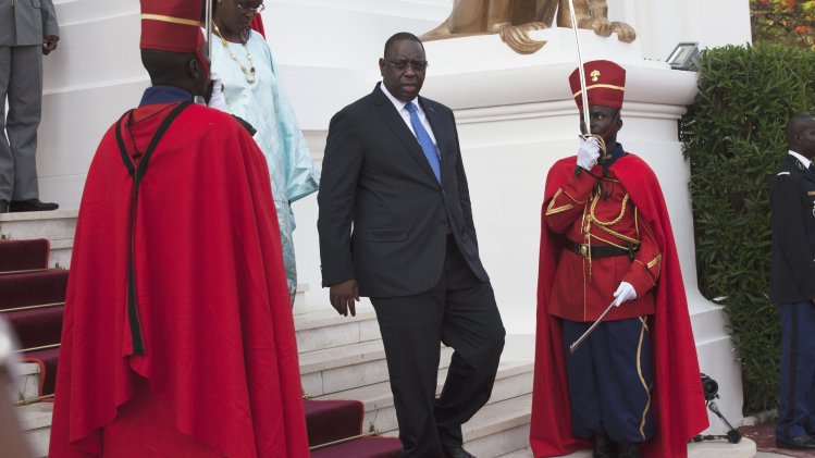 Senegalese President Sall walks down stairs to receive U.S. President Obama at presidential palace in Dakar