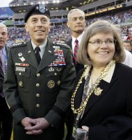 FILE - In this Feb. 1, 2009 file photo, Gen. David Petraeus, commander U.S. Central Command, left, stands with his wife Holly before the NFL Super Bowl XLIII football game between the Arizona Cardinals and the Pittsburgh Steelers in Tampa, Fla. Gen. Petraeus, the retired four-star general who led the U.S. military campaigns in Iraq and Afghanistan, resigned Friday, Nov. 9, 2012 as director of the CIA after admitting he had an extramarital affair. (AP Photo/David J. Phillip, File)