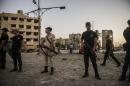 Egyptian riot police cordon the site where a bomb exploded outside a national security building in northern Cairo's district of Shubra on August 20, 2015, wounding six policemen