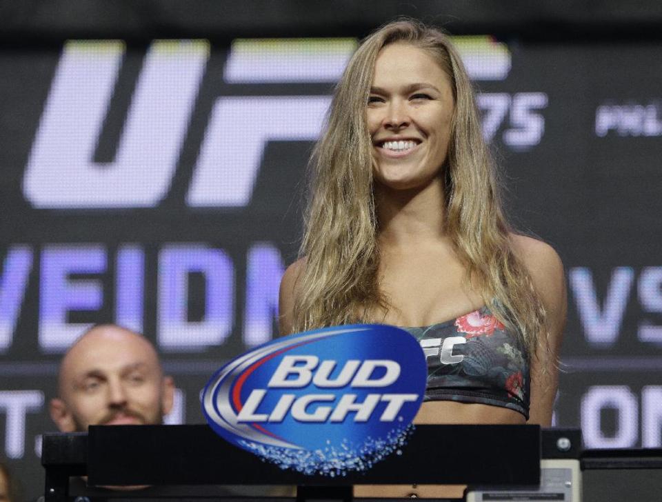 Ronda Rousey stands on the scale during a weigh-in for the UFC 175 mixed martial arts event at the Mandalay Bay, Friday, July 4, 2014, in Las Vegas...