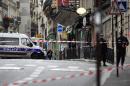 Police set up a cordon around the area where a suspect package was found in Rue De Clichy in the ninth district of Paris on November 16, 2015