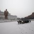 North Koreans bow in front of the statues of late North Korean leaders Kim Il Sung, left, and Kim Jong Il at Mansu Hill as it snows in Pyongyang, North Korea, Friday, Dec. 21, 2012. (AP Photo/Ng Han Guan)