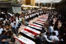 Iraqi mourners attend the funeral of members of the security forces who were killed the previous day in a suicide attack on an Iraqi police base north of Baghdad that killed at least 37 people, on June 2, 2015 in the holy Shiite city of Najaf