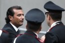 The captain of the Costa Concordia Schettino is surrounded by Italian Carabinieri policemen as he leaves at the end of the preliminary hearings in Grosseto