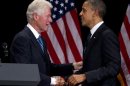 Former President Bill Clinton greets President Barack Obama to speak at a campaign event at the Waldorf Astoria, Monday, June 4, 2012, in New York. (AP Photo/Carolyn Kaster)
