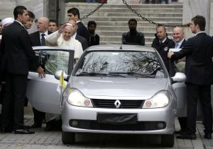 Pope Francis waves to journalists as he leaves the …