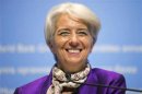 IMF Managing Director Lagarde smiles as she answers a questions during a news conference at the IMF and World Bank Annual Meetings in Tokyo