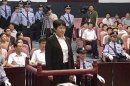 Gu Kailai, wife of ousted Chinese Communist Party Politburo member Bo Xilai, attends a trial in the court room at Hefei Intermediate People's Court