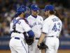 Toronto Blue Jays pitching coach Walker talks with starting pitcher Dickey and catcher Arencibia during the sixth inning agianst the Cleveland Indian in Toronto