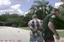 In this still image made from dash-cam video provided by the Lake Mary (Fla.) Police, George Zimmerman is detained by officers on Monday, Sept. 9, 2013. Police in central Florida have been focusing on a broken iPad in their investigation of a domestic dispute between George Zimmerman and his estranged wife Shellie this week. Shellie Zimmerman called 911, saying her estranged husband was in his truck and threatening her and her father with a gun. She also said her husband punched her father in the nose. Hours later, she told police she hadn't seen a gun. (AP Photo/Lake Mary (Fla.) Police)