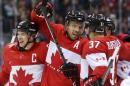 Canada defenseman Shea Weber, center, celebrates with forward Sidney Crosby, left, and forward Patrice Bergeron after scoring a goal against Norway in the second period of a men's ice hockey game at the 2014 Winter Olympics, Thursday, Feb. 13, 2014, in Sochi, Russia. (AP Photo/Julio Cortez)