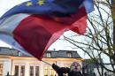 A protester waves flags of Poland and the European Union in front of the Polish Constitutional Court following a sentence regarding the appointment of judges in Warsaw on December 3, 2015