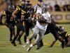 Oregon quarterback Marcus Mariota (8) scrambles for yardage as he is pursued by Arizona State defenders during the first half of an NCAA college football game, Thursday, Oct. 18, 2012, in Tempe, Ariz.  (AP Photo/Matt York)
