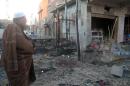An Iraqi man inspects the damage caused by a suicide attack in the northern city of Tuz Khurmatu, on November 24, 2013