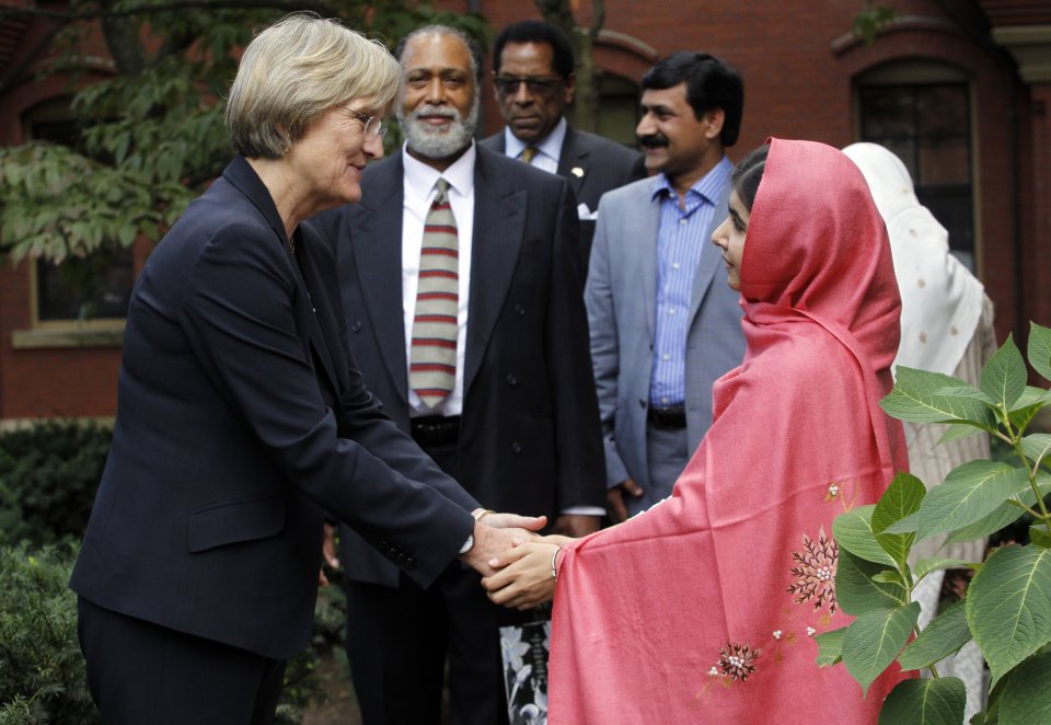 Malala Yousafzai, right, shakes hands with Harvard President Drew Gilpin Faust, left, after a news conference on the school's campus in Cambridge, Mass. on Friday, Sept. 27, 2013. The Pakistani teenager, an advocate for education for girls, survived a Taliban assassination attempt in 2012 on her way home from school. (AP Photo/Jessica Rinaldi)