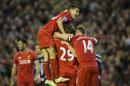Liverpool's Joe Allen is obscured by jubilant teammates including Philippe Coutinho, top, after scoring during the English Premier League soccer match between Liverpool and Newcastle at Anfield Stadium, Liverpool, England, Monday, April 13, 2015. (AP Photo/Jon Super)