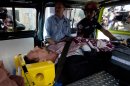 Software company founder John McAfee lies inside an ambulance, to be transferred from an immigration detention center to a hospital, in Guatemala City, Thursday, Dec. 6, 2012 . He was examined by a doctor at the detention center, who said that McAfee's heart and blood pressure were normal, but nonetheless was being moved to a hospital after McAfee was found lying on the floor in the room where he was being detained. McAfee who fled Belize was denied political asylum in Guatemala on Thursday and police in Belize said they expected him to be flown back soon for questioning about the killing of a fellow American expatriate. (AP Photo/Moises Castillo)