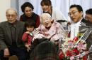 Misao Okawa (C), the world's oldest person, pictured on March 4, 2015 with her family at a nursing home in Osaka