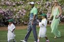Tiger Woods walks with his children Sam and Charlie and Lindsey Vonn during the Par 3 contest at the Masters golf tournament Wednesday, April 8, 2015, in Augusta, Ga. (AP Photo/David J. Phillip)