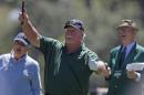 Craig Stadler (C) of the U.S. watches his hole-in-one on the first hole during the Par-3 tournament ahead of the 2011 Masters golf tournament in Augusta