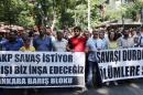 Demonstrators hold up a banner reading "The AKP wants war. We'll build peace" and "Stop the war" in Ankara on July 26, 2015