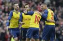 Arsenal's Theo Walcott, second right, celebrates after scoring a goal during the English FA Cup 4th round soccer match between Brighton & Hove Albion and Arsenal at the Amex Stadium, Brighton, England, Sunday, Jan. 25, 2015. (AP Photo/Tim Ireland)