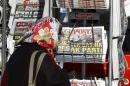 A woman looks at newspapers at a kiosk in Istanbul