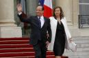 France's president Francois Hollande (L) and Valerie Trierweiler leave the Elysee presidential Palace in Paris on May 15, 2012