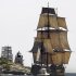 FILE - In this July 9, 2012, file photo, a replica of the historic ship HMS Bounty, right, sails past a lighthouse, center, as it departs Narragansett Bay and heads out to sea off the coast of Newport, R.I. The Coast Guard aid Monday, Oct. 29, 2012, that the 17 people aboard the HMS Bounty have gotten into two lifeboats, wearing survival suits and life jackets. The HMS Bounty, a tall ship, was in distress off North Carolina's Outer Banks as Hurricane Sandy swirls toward the East Coast. (AP Photo/Steven Senne, File)